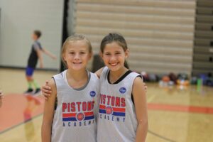 Two girls at Pistons Academy basketball camp