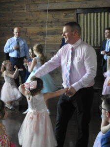 Man dancing with children at event